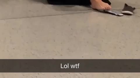 Girl in black sweater typing on phone with feet on floor