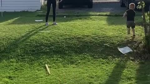 Cute baby boy hit home run while playing baseball with his mom