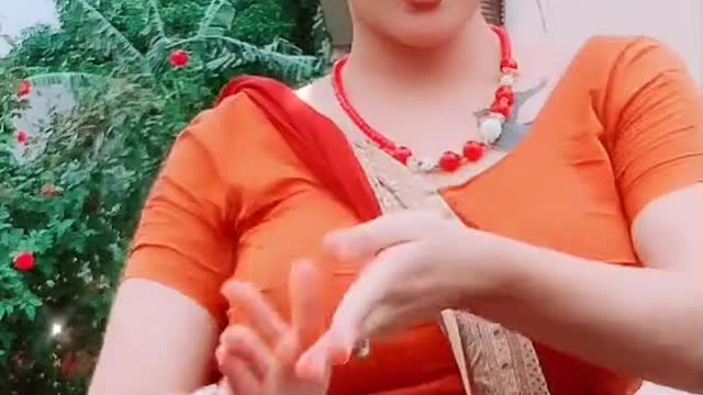Indian girl singging song with Orange dresses
