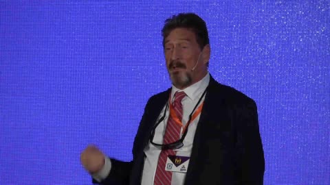 John McAfee gives speech at the Barcelona. Blockchain Week 2019.