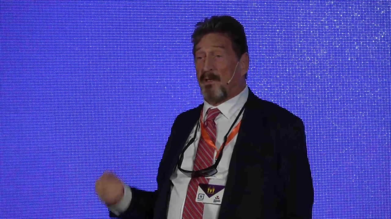 John McAfee gives speech at the Barcelona. Blockchain Week 2019.