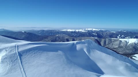 Snowy mountain range seen on a clear sky day