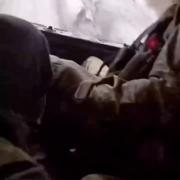 Ukraine military tows corpse in body bag