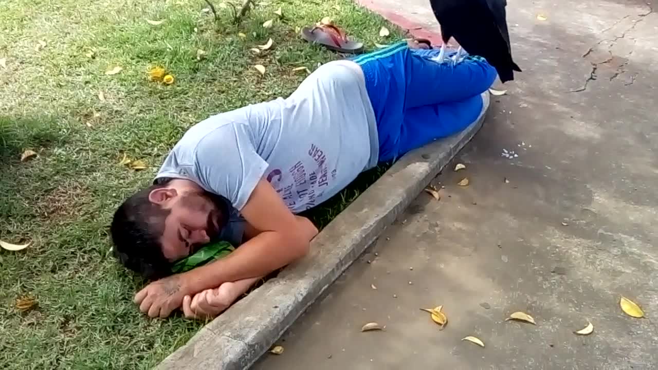 Vulture Sits on Sleeping Man