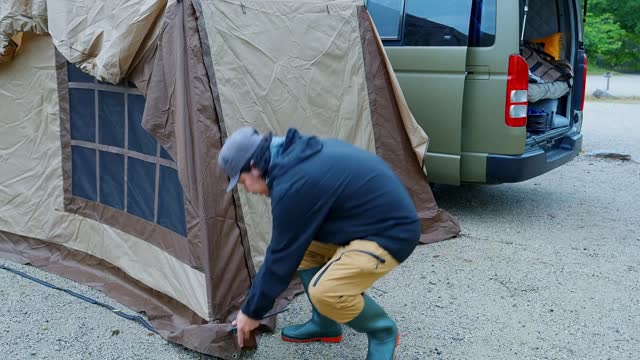 A man pitched a tent in the wild