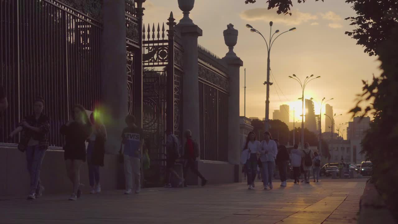 Some people walking the sunset time in the big city