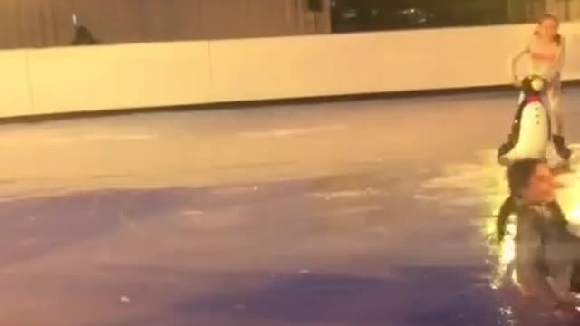 Girl grey shirt falling down while ice skating