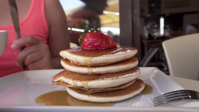 Maple Syrup Poured on to Pancakes