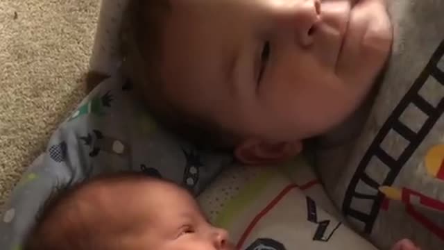 2 year old teaching his newborn sister manners