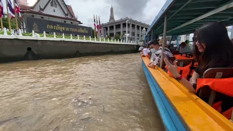 Feeding fish at Chao Phraya River in Thailand