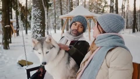 Couple Enjoying with their Dog in Snow