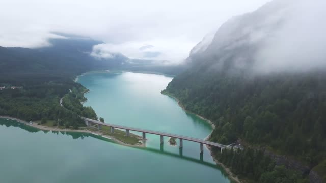 Drone Footage of Mountain Forest and a Bridge Above the Lake