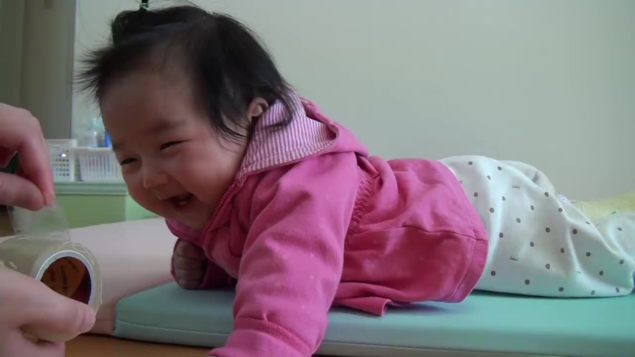 Cute little baby laughing at a tape so sweet and funny