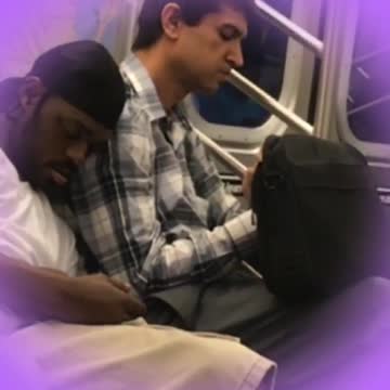 Man in white shirt sleeps on man with blue flannel