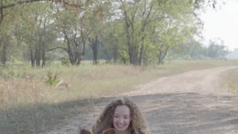 Woman Sitting on the Ground With Dogs