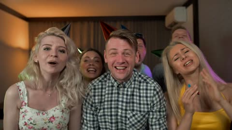 Excited young people partying with party hats