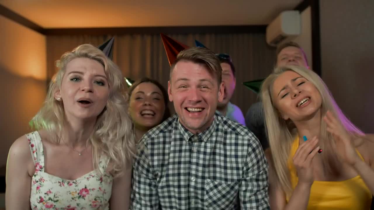 Excited young people partying with party hats