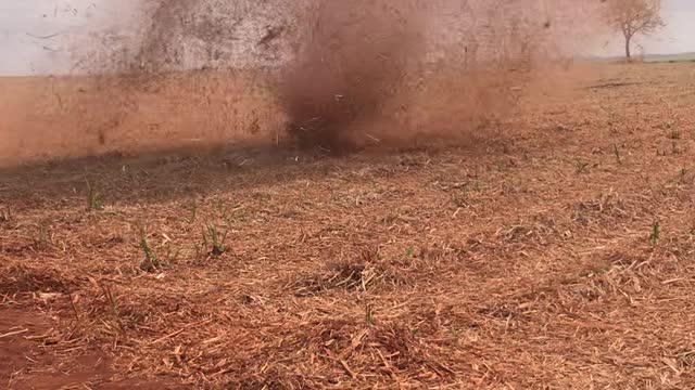 Dust Devil Drifts Across Field