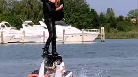 Teacher-Student Duo Dances While Hydroflying Over Water