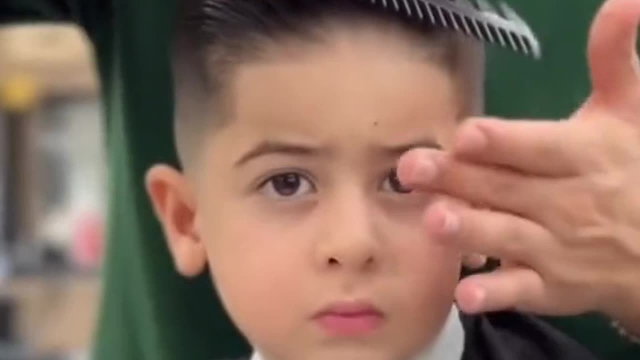 Little boy doing her hair dressing