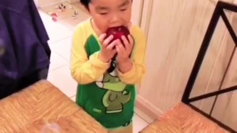 Funny apple eating baby boy