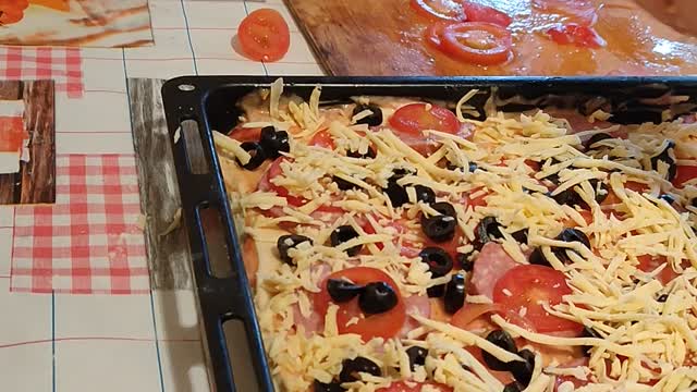 Child takes pizza toppings while nobody sees