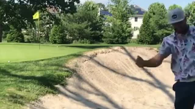 A man with a hat played golf and failed