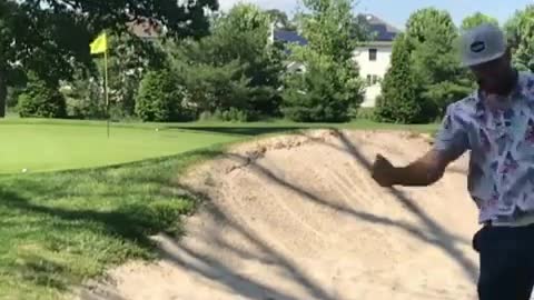 A man with a hat played golf and failed