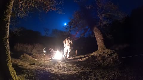 Nightlapse of the moon over a campfire. Wildcamping