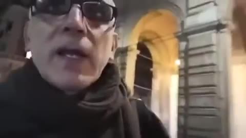 A PRIEST LAYS OUT WHOSE IN THE BACKGROUND PULLING THE STRINGS