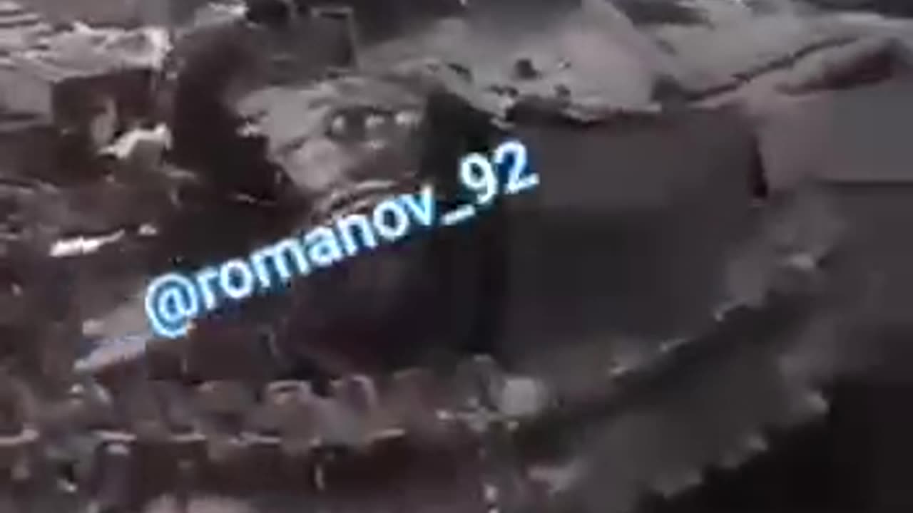 Russian Soldier Films a Destroyed Tank