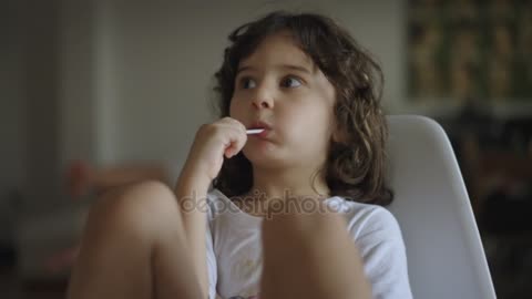 portrait Little Boy Eating Sweet Lollipop Sitting White Plastic Chair