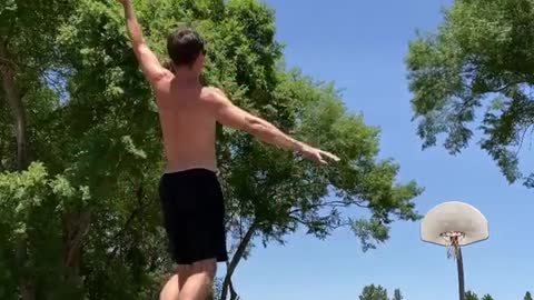 Guy Scores Basket While Balancing Himself Over Another Basketball