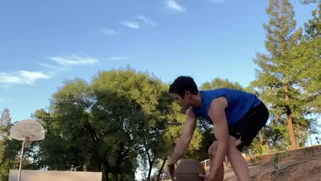 Man Scores Basket While Balancing On Slackline And Dribbling Basketball