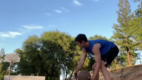 Man Scores Basket While Balancing On Slackline And Dribbling Basketball