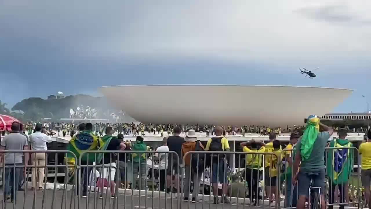 Brazil - Federal Police helicopter drops tear gas bombs towards protesters