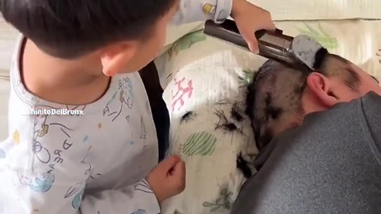 little boy playing barber