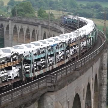 A long Audi train pulled by a Siemens Smartron
