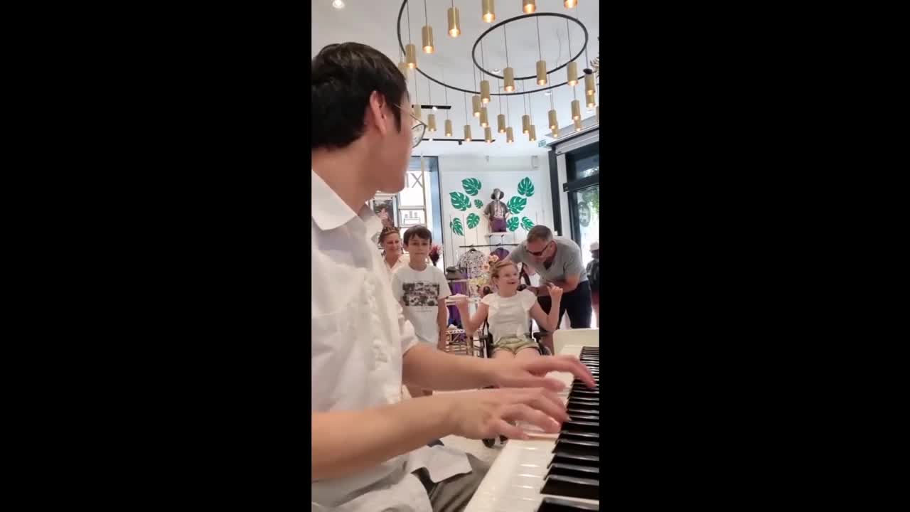 Girl in wheelchair moved by piano performance