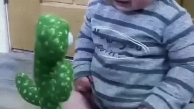 Funny crying baby talking to cactus toy