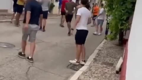Girl busy with her phone at the middle of bull run