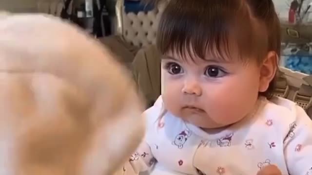 This baby is angry at his doll while his mother is confused