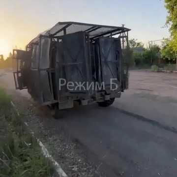 Russian GAZ-2975 Tigr fitted with anti-drone field-manufactured armored protection