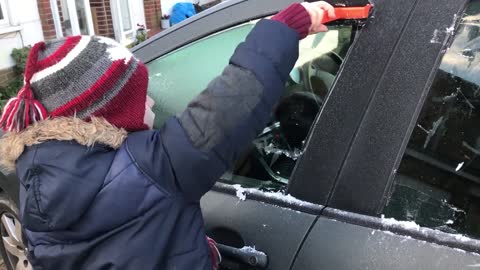 Kids Scrape Ice From Car's Windows