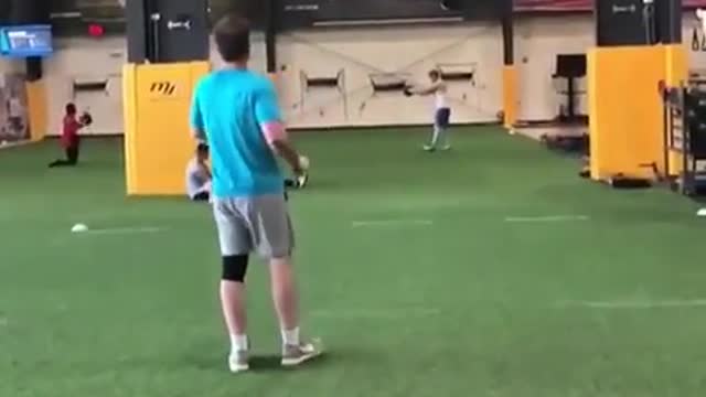 Two young guys playing frisbee indoors