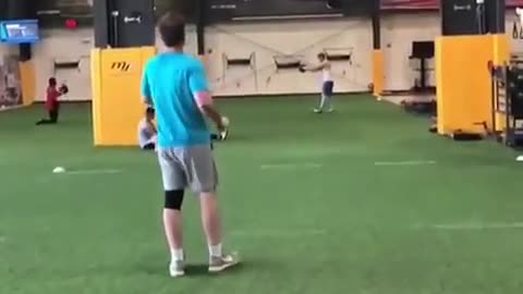 Two young guys playing frisbee indoors