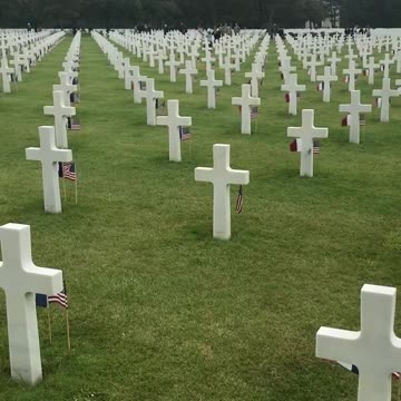 American and French flags wave by headstones on 79th anniversary of D-Day in Normandy