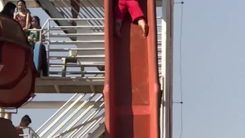 Guy on Slide Collides with Unsuspecting Swimmer