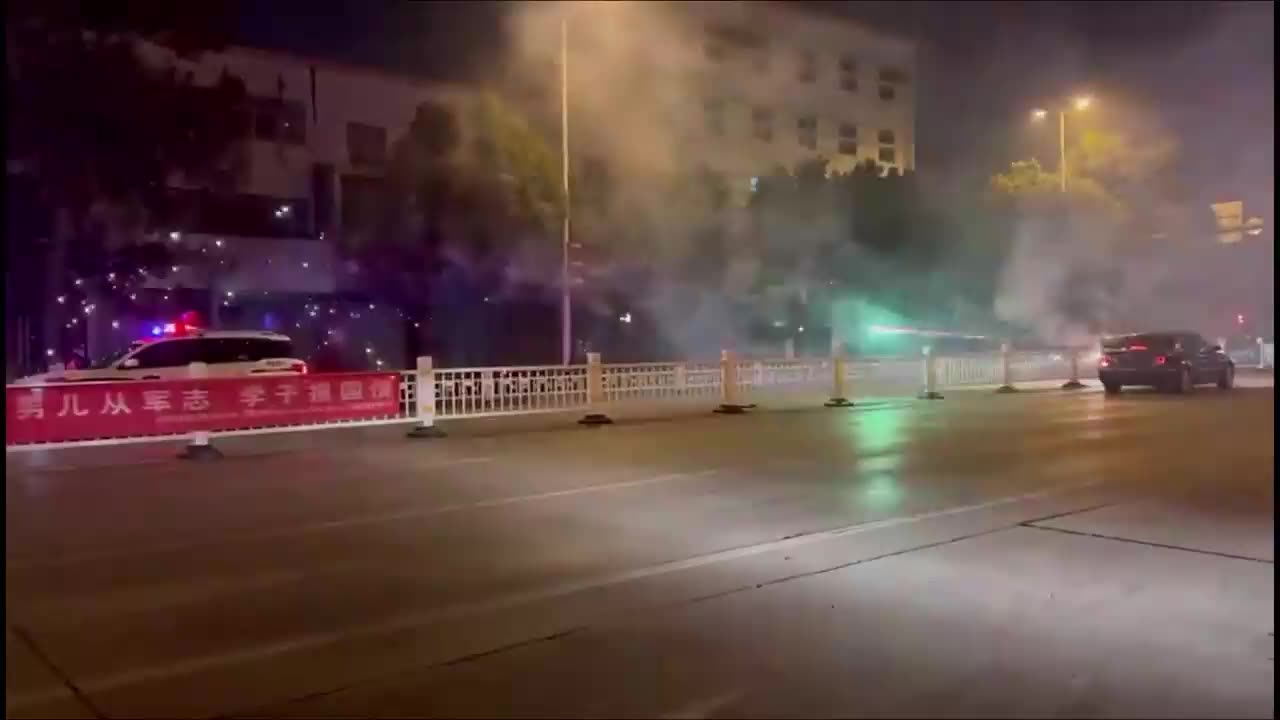 A black vehicle fires fireworks at a police car in Zaozhuang, Shandong province