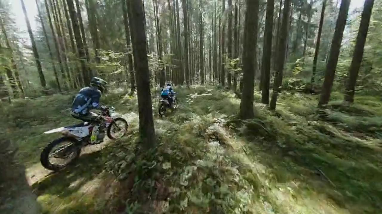 Two Guys Ride Their Dirt Bike Through Woods